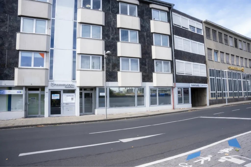 Außenansicht der Zahnarztpraxis Zahnfreunde Euskirchen mit Praxiseingang und Parkplatz
